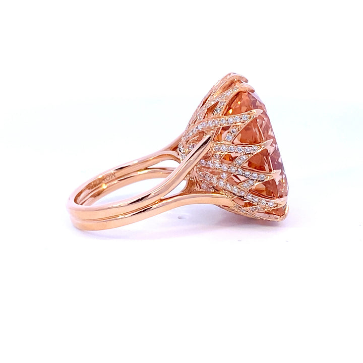 Elongated cushion cut Champagne, peach Morganite cocktail ring set with a cross hatched diamond basket view from side 