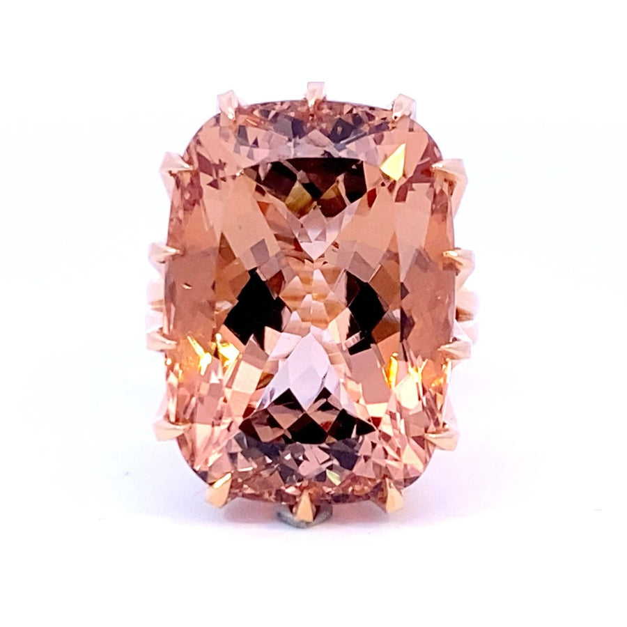 Elongated cushion cut Champagne, peach Morganite cocktail ring set with a cross hatched diamond basket view from front 