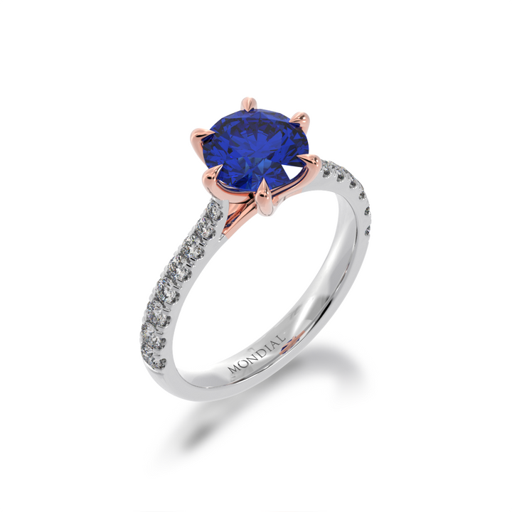 Side standing 45 degree view of the Mondial by Nadia Round Brilliant cut Blue Sapphire engagement ring with a diamond set band.