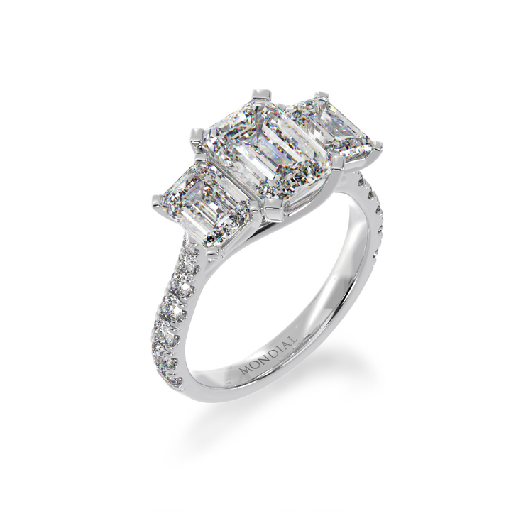 Emerald cut diamond trilogy ring with a diamond set band from angle