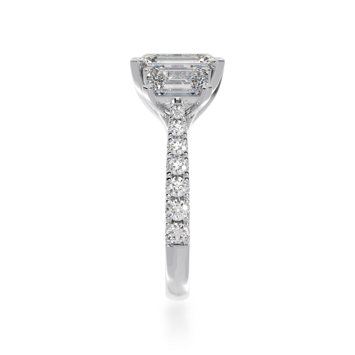 Emerald cut diamond trilogy ring with a diamond set band from side