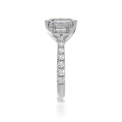 Emerald cut diamond trilogy ring with a diamond set band from side