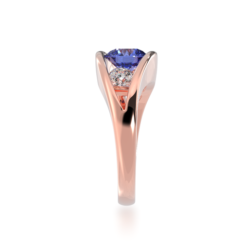 The Mondial by Nadia Flame design round brilliant cut blue sapphire engagement ring with diamonds in rose gold view from side.