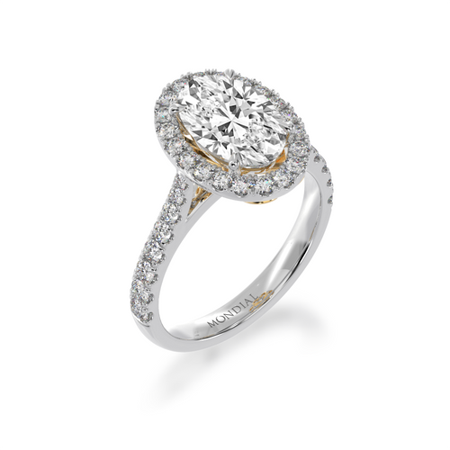 Oval cut diamond halo ring on diamond set band from standing 45 degree angle view.