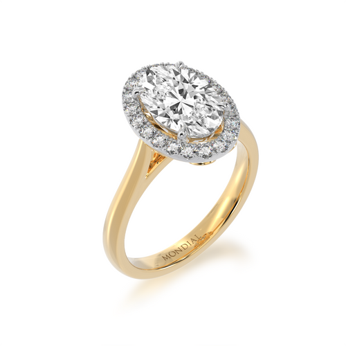 Oval diamond halo on yellow gold band from angle from standing angle view.