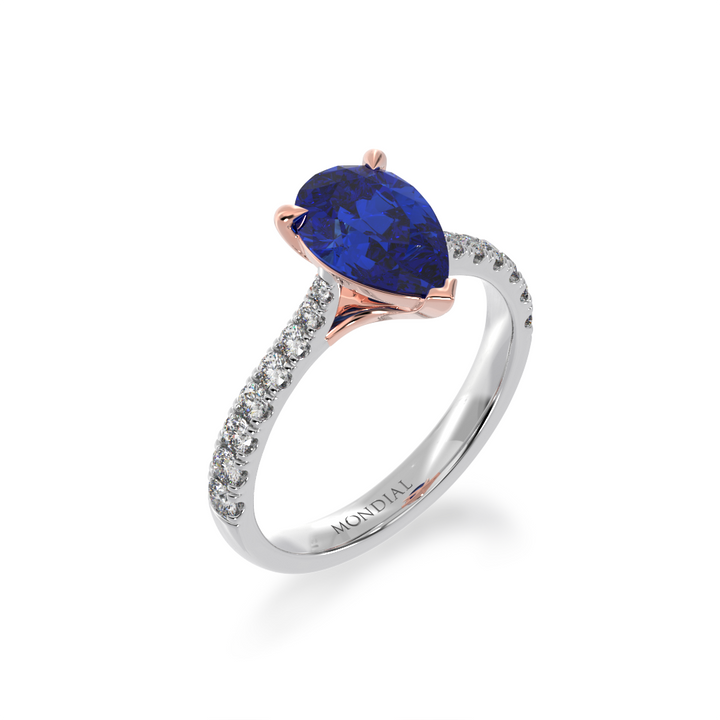 Pear shaped blue sapphire solitaire ring with diamond set band view from angle