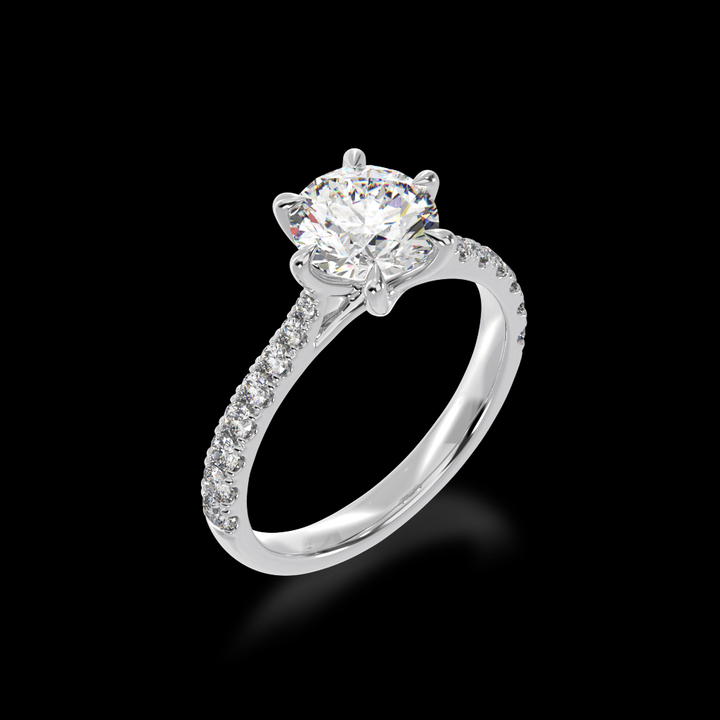 Round brilliant cut diamond solitaire engagement ring with diamond set band view from angle