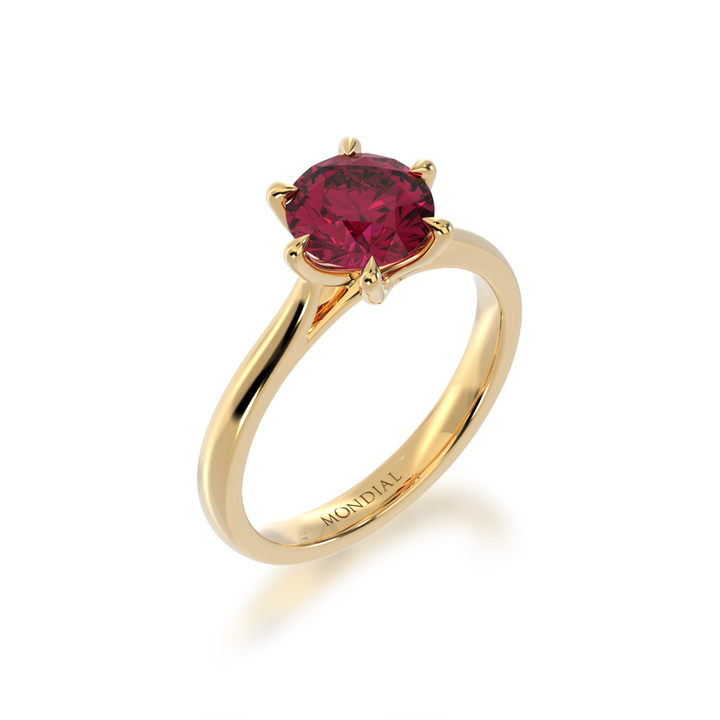 Brilliant cut ruby solitaire on a yellow gold band from angle
