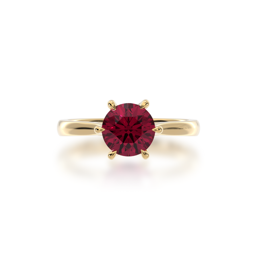 Brilliant cut ruby solitaire on a yellow gold band from top
