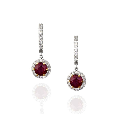 Pair of earrings with red ruby gemstones and diamond accents.