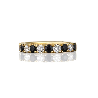 Yellow gold ring with black sapphires and white diamonds.