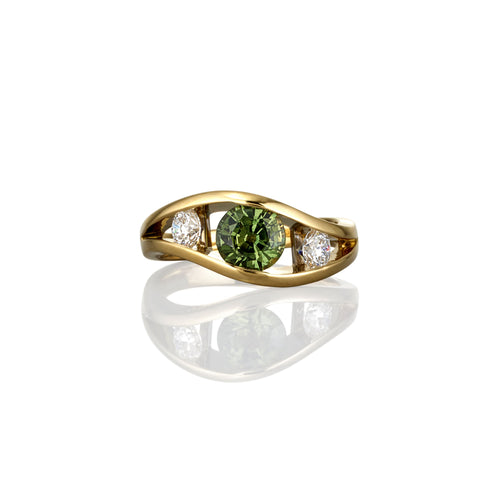 Gold ring with a green sapphire gemstone and two smaller white diamonds on either side