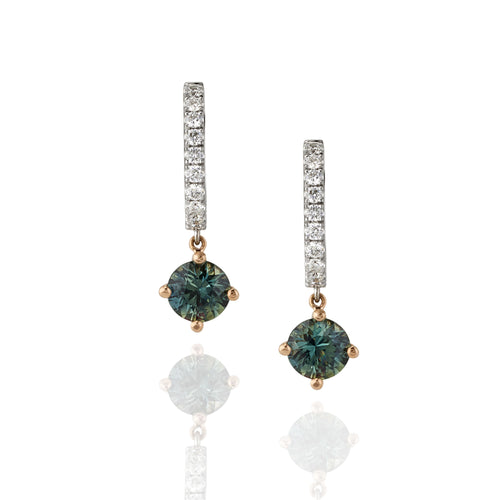 Pair of drop earrings with green sapphire gemstones and white diamond accents shown on a white background