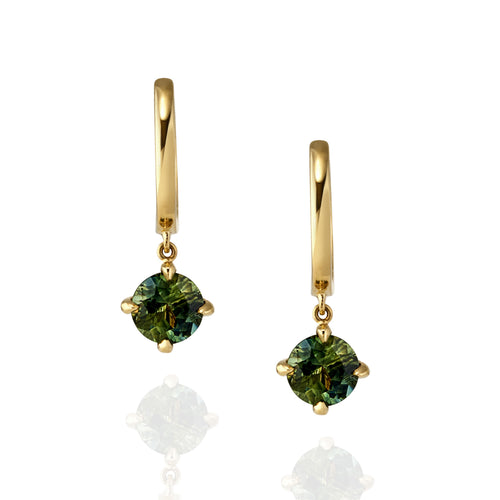 Gold drop earrings with green sapphire gemstones on a white background
