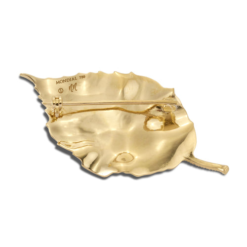 Back view of gold single leaf brooch showing the pin clasp on a white background.