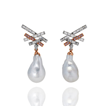 A set of earrings with emerald cut white diamonds and argyle pink diamonds attached to a south sea pearl to create a drop earring