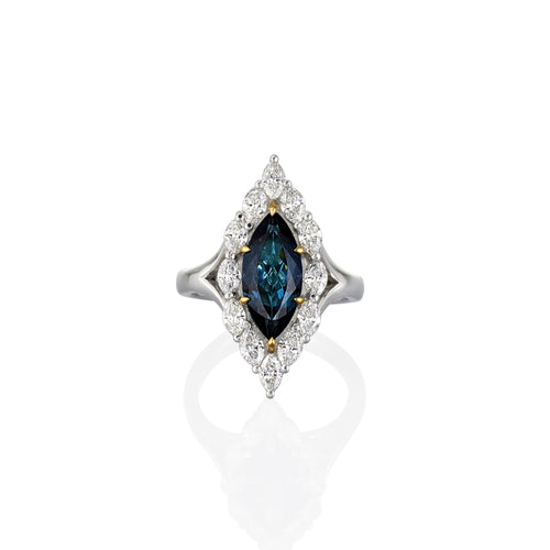 Ring with blue gemstone and diamond accents on a white background