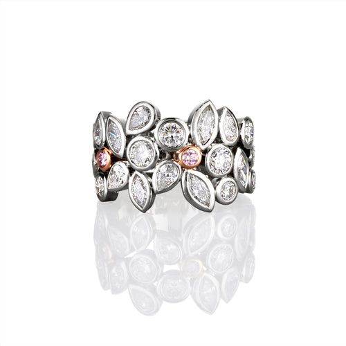 Platinum dress ring with white diamond and argyle pink diamond accents on a white background