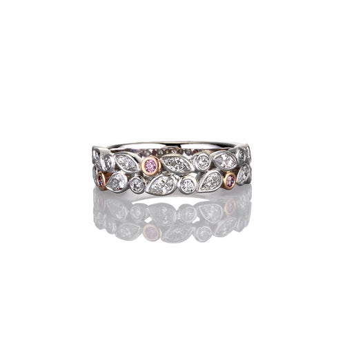 Platinum ring with rose gold accents and white diamond and Pink Argyle Diamond gemstones on a white background