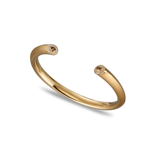 Gold bracelet with white and pink diamonds on a white background