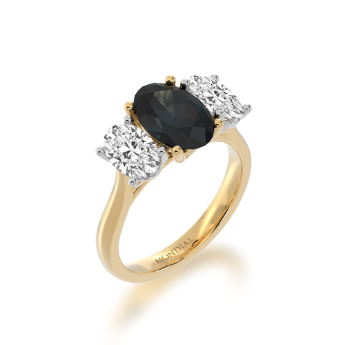 Trilogy oval  diamond ring with a black sapphire on yellow gold band view from angle.