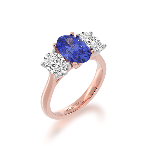 The Mondial by Nadia Trilogy oval cut blue sapphire engagement ring with diamonds on rose gold band view from angle.