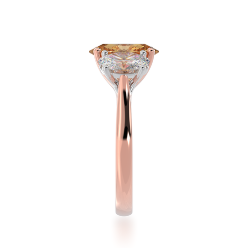 Trilogy oval cut champagne and diamond ring on rose gold band view from side.