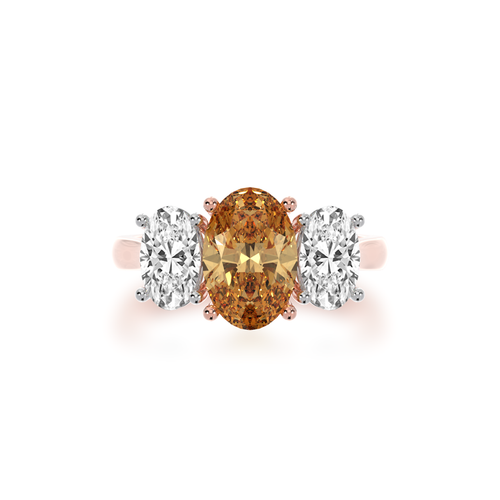 The Mondial by Nadia Trilogy Oval diamond ring with a champagne diamond on rose gold band view from top.