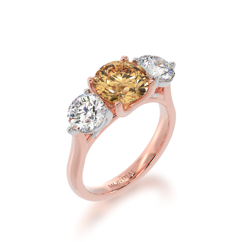 Trilogy round brilliant cut champagne and diamond ring on rose gold band view from angle 