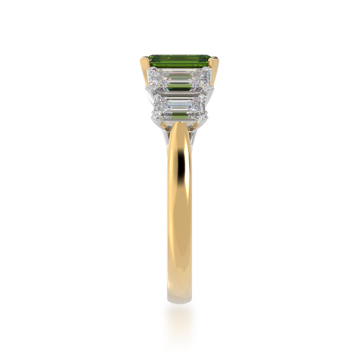 Five stone emerald cut green sapphire and diamond ring on a yellow band view from side 