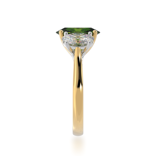 Trilogy oval cut green sapphire and diamond ring on a yellow gold band view from side.