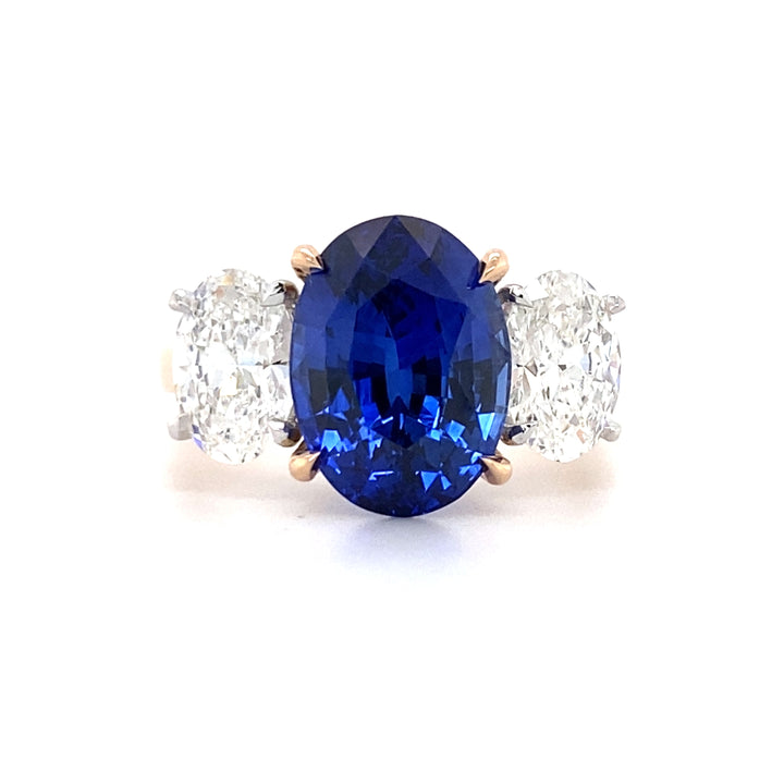 Trilogy oval cut blue sapphire and diamond ring on rose gold band