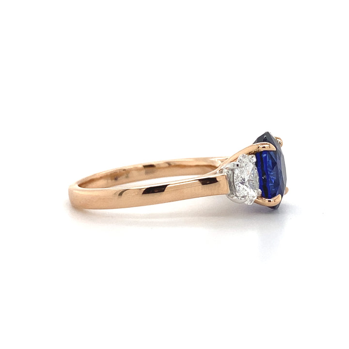 Trilogy oval cut blue sapphire and diamond ring on rose gold band