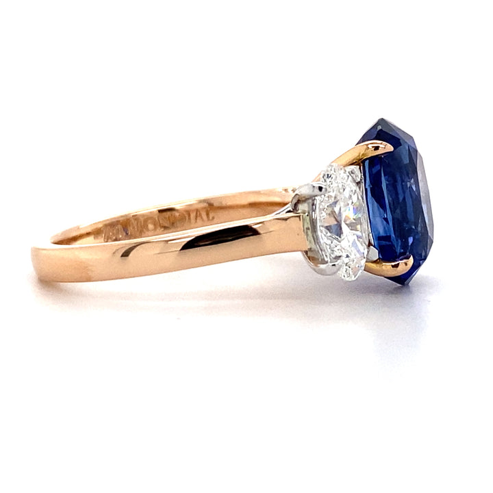 Trilogy oval cut blue sapphire and diamond ring on rose gold band