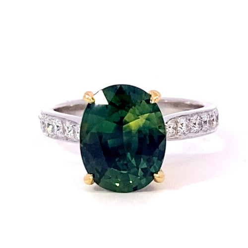 Oval cut green sapphire ring with diamond band