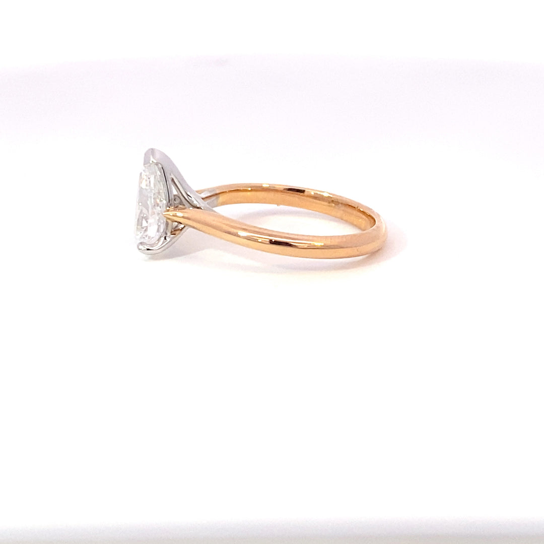 Pear shape diamond solitaire ring on rose gold band