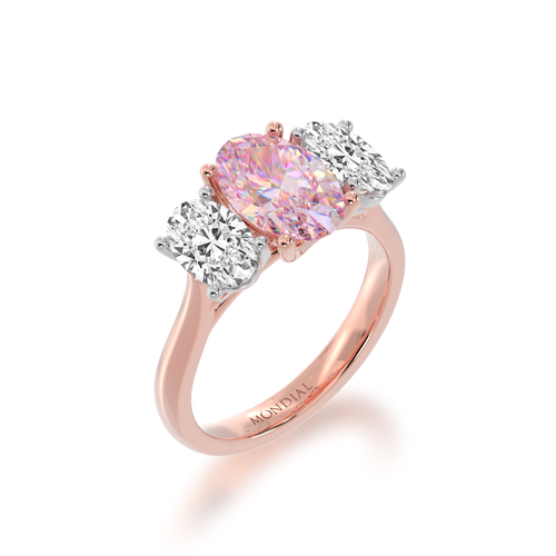 Trilogy oval diamond ring with a pink sapphire on rose gold band view from angle.