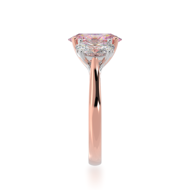 Trilogy oval cut pink sapphire and diamond ring on rose gold band view from side 