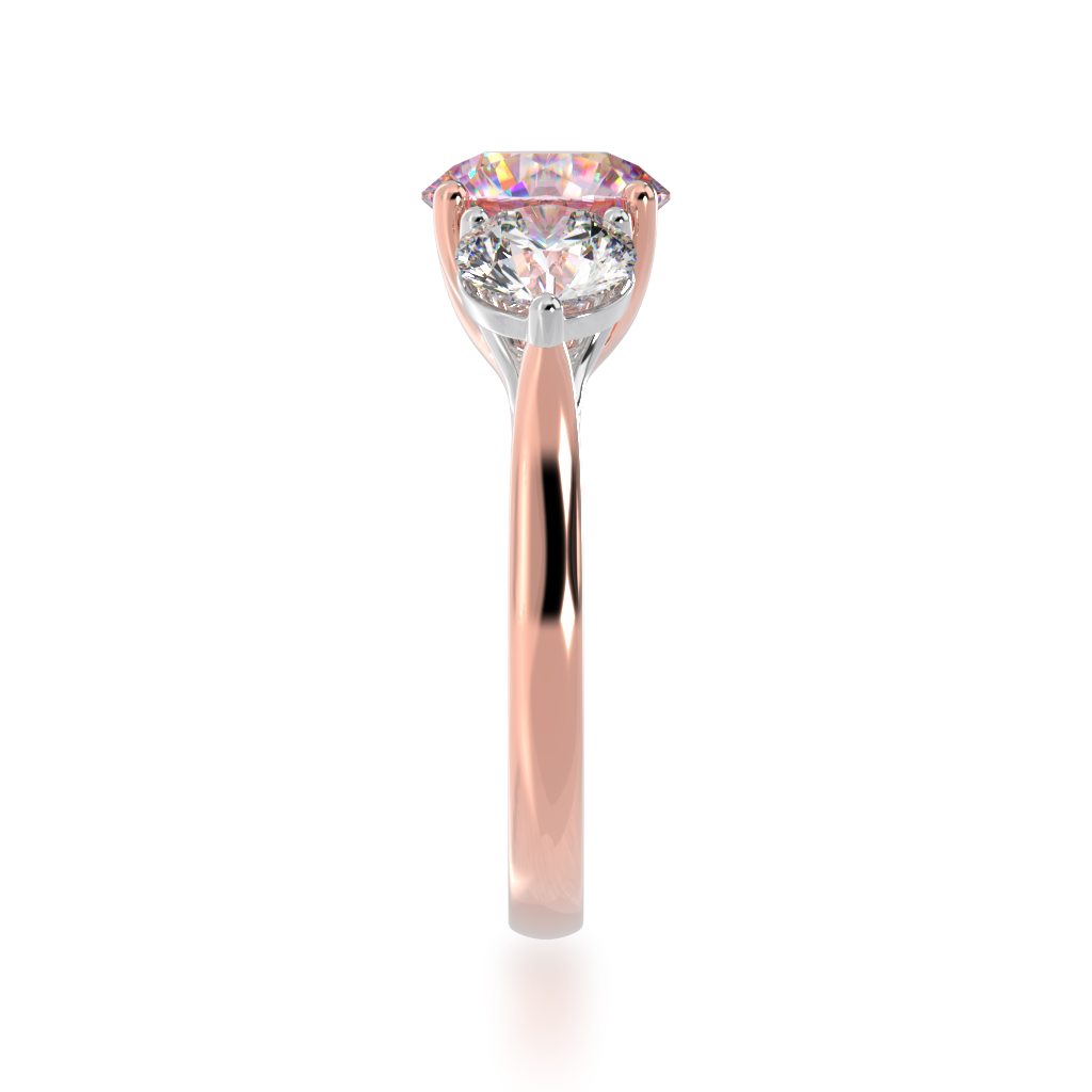 Trilogy round brilliant cut pink sapphire and diamond ring on rose gold band view from side 