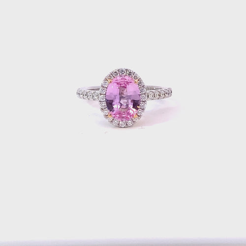 Oval cut pink sapphire diamond halo ring with diamond band