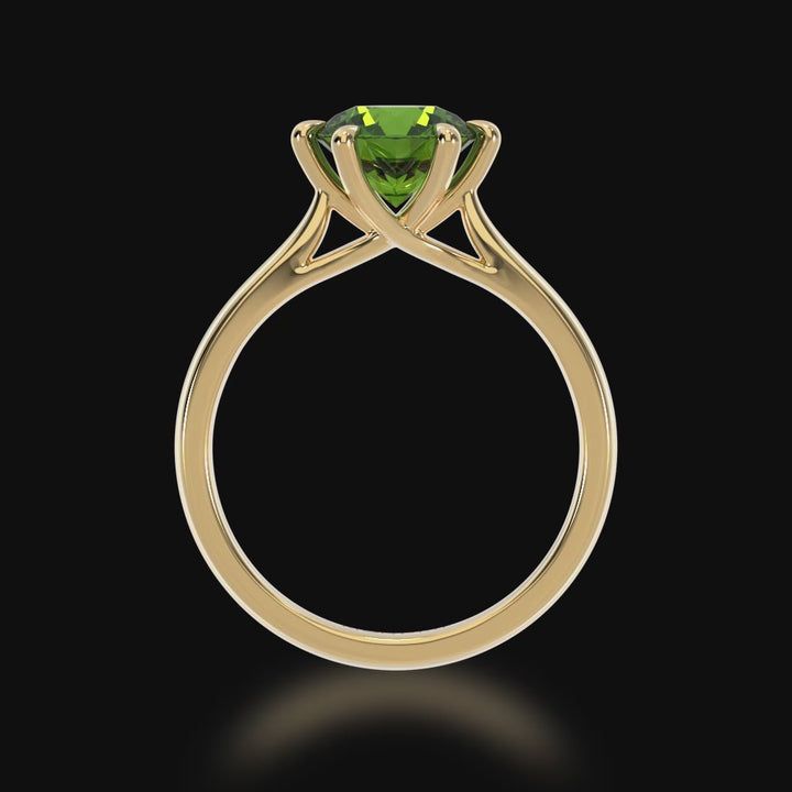 Brilliant cut green sapphire solitaire on a yellow gold band 3d video