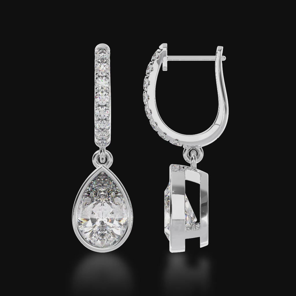 Pear shape bezel set diamond drop earrings on a diamond set huggie 3d video