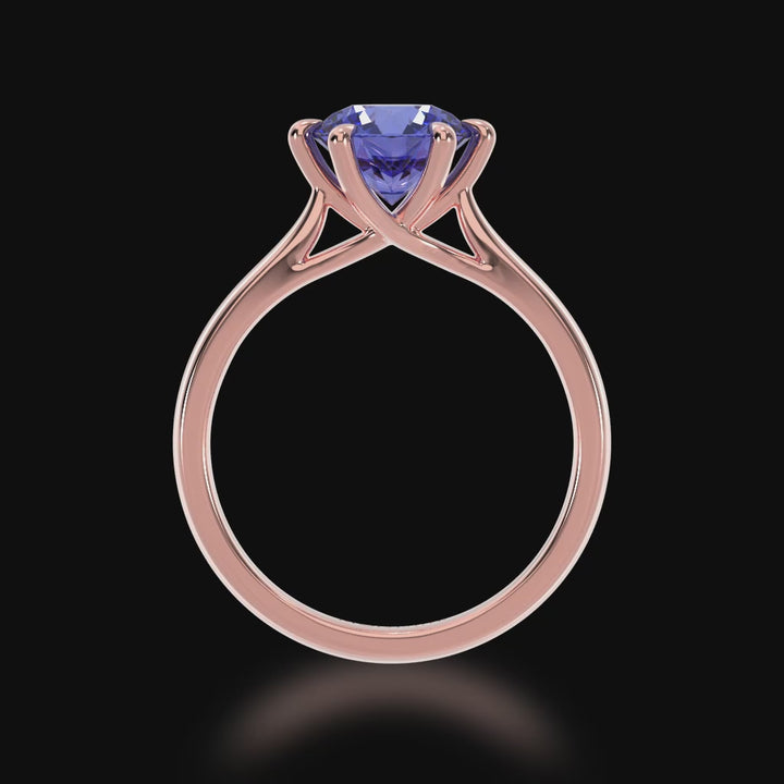 Brilliant cut blue sapphire solitaire on a rose gold band 3d video