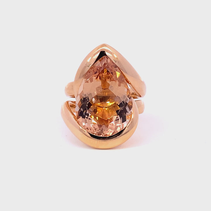 Pear shaped champagne peach coloured morganite ring in infinity design in rose gold video