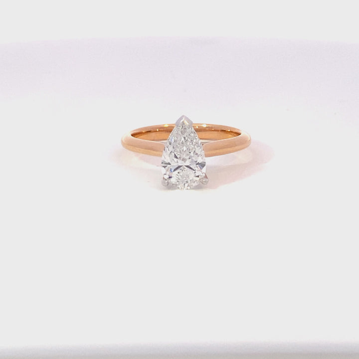 Pear shape diamond solitaire ring on rose gold band