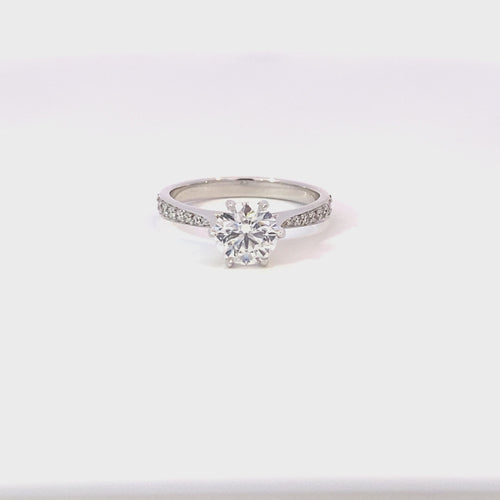 Round brilliant cut diamond solitaire with diamond set band