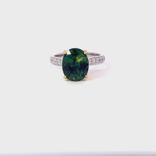 Oval cut green sapphire ring with diamond band