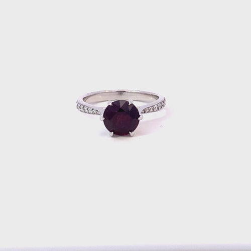 Round brilliant cut ruby ring with diamond band