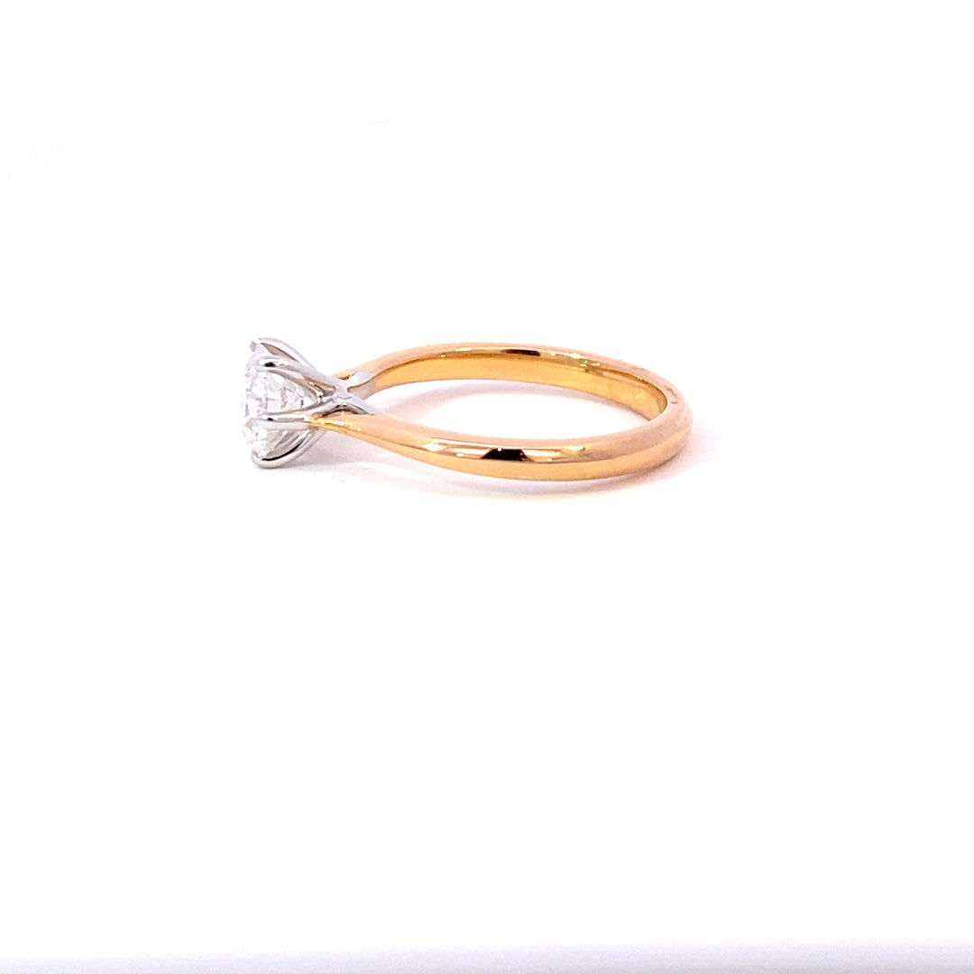 Round brilliant cut diamond solitaire ring on rose gold band