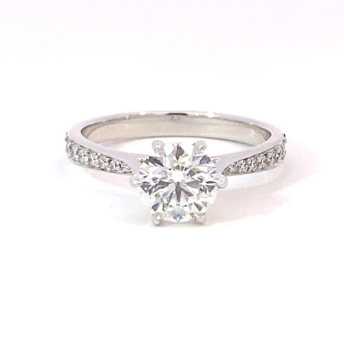 Round brilliant cut diamond solitaire with diamond set band